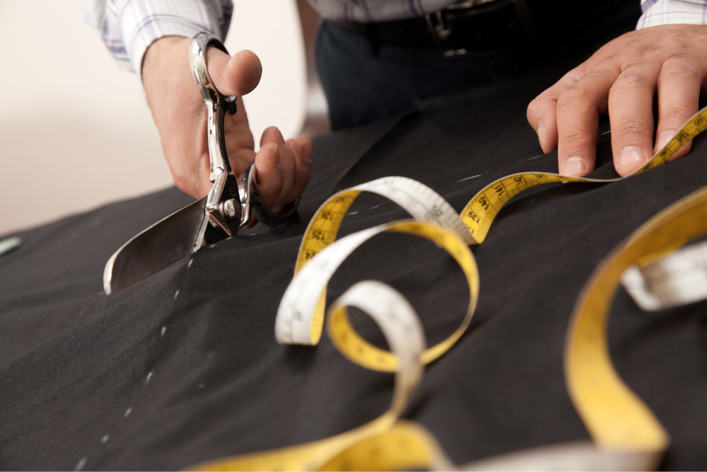 A person skillfully cutting fabric using a pair of scissors.